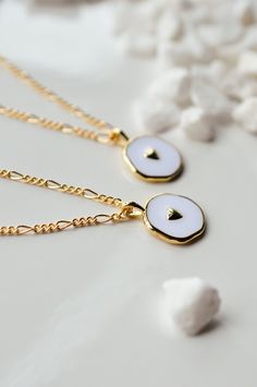 This is a new favorite minimal charm necklace. It's SO pretty. White charm with a gold heart in the middle, and it's hanging from our logan chain. Layer this up with a Luna necklace and you've got a really beautiful stack. Gold-filled is the closest alternative to solid gold. Gold filled jewelry has a thick layer of solid gold bonded onto the base layer, usually brass or sterling silver. Compared to gold plated which uses a process of electroplating that quickly dips your jewelry in gold, result Luna Necklace, Delicate Jewellery, Heart Charm Necklace, Gold Bond, Delicate Jewelry, Gold Heart, Dark Wallpaper, Gold Filled Jewelry, Gold Design