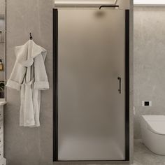 a white toilet sitting next to a walk in shower