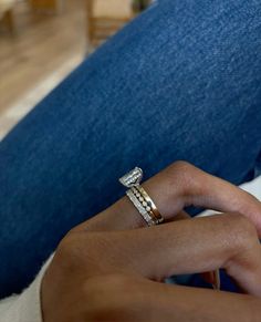 a close up of a person's hand with a ring on their left wrist