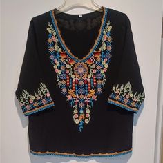 Like New! Never Worn. Unbranded Black Boho Beachy V-Neck Blouse With Floral Embroidery Front And Back! 3/4 Sleeves, Loose Fit, Fully Lined. Material Is Cotton Rayon Blend. Excellent Quality. No Stains, Rips, Or Pulls. Multicolor Embroidered V-neck Top For Vacation, Bohemian Multicolor Embroidered V-neck Top, V-neck Blouse With Multicolor Embroidery For Vacation, Beach V-neck Top With Embroidered Neckline, Bohemian Half Sleeve Blouse For Vacation, Bohemian Half Sleeve Beach Blouse, Bohemian Half Sleeve Blouse For Beach, Embroidered Black Beach Blouse, Bohemian Black Tops With Embroidered Neckline