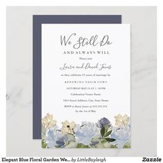 a wedding card with blue flowers and greenery on the front, in grey and white