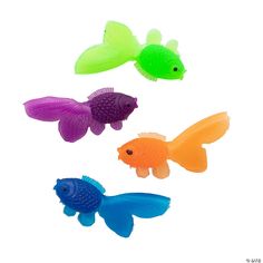 three different colored plastic fish on a white background