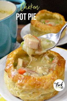 a spoon scooping soup out of a pot pie on top of a white plate