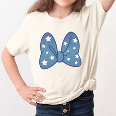 Rock the Fourth in style with this Blue Bow With White Stars Graphic Tee! Featuring a playful Minnie Mouse bow design, this shirt is perfect for a fun and patriotic look. Stand out from the crowd and celebrate in comfort and fashion. Design is Printed Direct to Garment. See Size Guide for Bella Unisex Tee Stars Graphic, Minnie Mouse Bow, Size Matters, White Stars, Graphic Tee Design, Bow Design, Blue Bow, Comfy Hoodies, We Wear