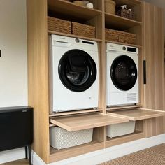 a washer and dryer in a room with wooden shelves