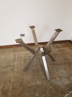 a metal sculpture sitting on top of a cement floor