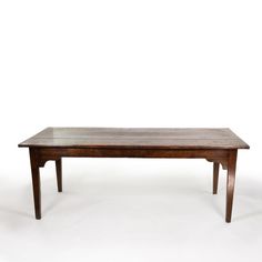 a wooden table sitting on top of a white floor