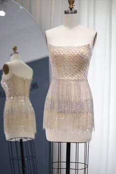 This transparent rhinestone and fringe tassel mini dress is perfect for any occasion! In addition to the crisscross rhinestone and crystal beaded bodice, this dress features cascading layers of sparkling crystals tassels along the bottom, providing eye-catching sparkle. There is a bra cup built into the dress. If you want coverage in those special areas, Spanx, a bra, underwear, a slip or whatever you choose can be worn underneath! Glamorous Beaded Fringe Mini Dress For Prom, Rhinestone Dress For Glamorous Events During Prom Season, Rhinestone Dresses For Prom And Glamorous Events, Rhinestone Dress For Prom Season And Glamorous Events, Glamorous Rhinestone Fringe Mini Dress For Wedding, Glamorous Mini Dress With Rhinestone Fringe For Wedding, Glamorous Wedding Mini Dress With Rhinestone Fringe, Wedding Mini Dress With Rhinestone Fringe, Glamorous Dresses With Rhinestone Fringe For Glamorous Events