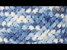 the blue and white crocheted blanket is on display