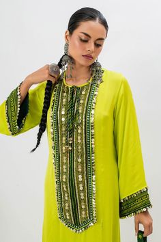 Green long kurta with hand embroidered ajrakh patch yoke in front. Comes with pant with boho detailing on hem.
Components: 2
Pattern: Embroidered
Type Of Work: Ajrakh, Sequin, Zari, Thread
Neckline: Round
Sleeve Type: Full
Fabric: Satin
Color: Green
Other Details: 
Note: Potli bag held by the model is not for sale
Occasion: Mehendi and Haldi - Aza Fashions Chanderi Straight Kurta For Festivals, Festival Chanderi Straight Kurta, Straight Kurta With Dupatta For Festival, Festival Straight Kurta With Dupatta, Festive Bohemian Mulmul Kurta, Unstitched Chanderi Kurta For Festivals, Transitional Festival Kurta With Zari Work, Unstitched Bohemian Kurta For Navratri, Semi-stitched Bohemian Kurta With Traditional Patterns