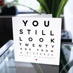 a card with an eye chart on it that says you still look twenty one from a distance happy birthday