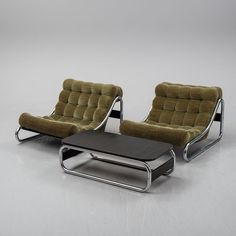 two lounge chairs and a footstool are shown