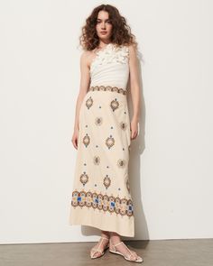 This soft a-line skirt is intricately embroidered in bold blue, rich tan, and soft sand coloring detailing a floral-inspired motif. Complement the high-rise waist with the matching top or a flowy t-shirt. Side-zip closure Length from Highest Point to Hem: 36 1/2" Detailed embroidery throughout Side slits Cotton Poplin Spring Floral Embroidered Maxi Skirt, Spring Floral Embroidered Flared Skirt Dress, Chic Floral Embroidered Skirt For Spring, Chic Spring Skirt With Floral Embroidery, Spring Flared Dress With Floral Embroidery, Spring Floral Embroidered Flared Dress, Chic Floral Embroidery Skirt For Spring, Spring Dress With Floral Embroidery And Flared Skirt, Elegant Summer Skirt With Floral Embroidery