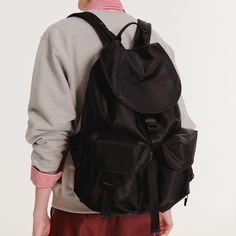 Introducing our Two Pocket Nylon Cargo Rucksack – the perfect blend of style and functionality. This bag is made of nylon and features a sleek black colour. With 8 compartments, including a laptop sleeve, it can securely hold up to a 17-inch laptop. The unique side zipper access to the main compartment, triangle rings, webbing details, and a cushioned shoulder strap add both convenience and style. Built to last with YKK® zippers and matte nickel-plated metal components. Elevate your daily commute with this essential accessory. Composition: Nylon 100% Care: Hand wash only, cold water Web Detail, Triangle Ring, Hold Ups, Black Colour, Fashion Jewellery, Independent Designers Fashion, Contemporary Fashion, Laptop Sleeve, Badger