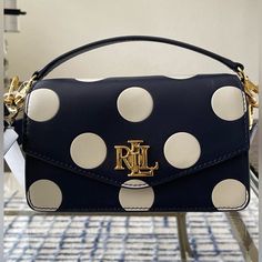 Nwt Ralph Lauren Convertible Handbag With Two Straps For Crossbody And Hand Held. Made From Finely Tanned Leather In Navy Blue And Cream Polka Dot Motif. Double Gusset Interior Zip Pocket Gold Tone Hardware With Ralph Lauren Stamps Adjustable Crossbody Strap 17”-21” Drop Handle Held Handle 3.5” Drop 7.5”L X 5”H X 2.5”D Ralph Lauren Storage Bag Comes To You From A Non-Smoker And Pet-Free Home Rll Ralph Lauren Bag Handbags, Blue Flap Bag With Dust Bag, Ralph Lauren Satchel Shoulder Bag With Detachable Strap, Ralph Lauren Top Handle Formal Bag, Navy Top Handle Bag With Detachable Strap, Luxury Navy Crossbody Bag, Chic Navy Crossbody Bag, Ralph Lauren Formal Top Handle Bag, Ralph Lauren Formal Shoulder Bag