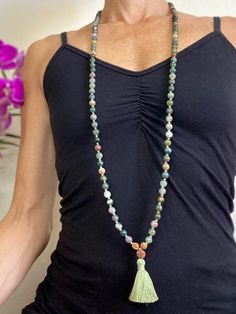 This green (and some blue-ish) moss agate mala bead necklace has the traditional 108 8mm beads, dipped in the holy river Ganges for spiritual potency! Moss agate is said to encourage tranquility and emotional balance. Moss agate is the perfect stone for those who experience strong aggression or overly nurturing emotions, helping to balance male and female energies whenever they become too extreme. Moss Agate is a stone of new beginnings. Refreshes the soul and enables you to see beauty in all you behold. Moss Agate reduces sensitivity to weather and environmental pollutants. It attracts abundance in wealth and improves self-esteem. Green Mala With 8mm Beads For Healing, Green Gemstone Beads Mala For Healing, Green Hand-strung Spiritual Mala, Green Spiritual Mala With 108 Beads, Bohemian Moss Agate Necklaces For Meditation, Spiritual Jade Beaded Necklaces For Meditation, Green Beaded Mala For Healing, Agate Gemstone Beads Mala For Healing, Green Ocean Jasper Necklace For Healing