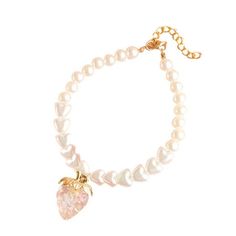 a bracelet with pearls and a strawberry charm on the clasp, hanging from a gold plated chain