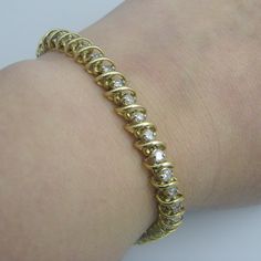 "For sale: (1) d933 14k Yellow Gold Diamond Bracelet PLEASE READ ENTIRE DESCRIPTION BEFORE PURCHASING Pre-owned item. Good condition. Please see pictures for details. Sold as is, as seen on pictures. This bracelet contains 42 diamonds, all of which are round cut. It is not stamped, but has been tested for authenticity. Specifics: 14k Yellow gold Hook clasp Diamonds: 4.2TCW Length: 7.25 inches Width: 7.3 mm Total Weight: 17 grams Please be 100% sure of your purchase before buying, as we do not of Gold Diamond Bracelet, Diamond Bangles Bracelet, Thread Earrings, Bracelets Gold Diamond, Wedding Jewelry Bracelets, Fish Hook Earrings, Diamond Bangle, Hook Clasp, Jewelry Women