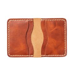 A Leather Wallet that Ages Gracefully and Beautifully.Ever owned a wallet that fell apart after a year or two? Not only do our wallets get better after years of use, but we guarantee it. The rustic English Tan leather stands up to a lifetime of carrying. Drop your wallet while rock climbing, step on it by accident, or run over it in a car. Your experiences will add patina and character to this wallet, not destroy it.Our full-grain leather means your wallet will develop character and patina. We h Full Grain Leather Wallet, Horween Chromexcel, Wallet Minimalist, Horween Leather, Leather Stand, In A Car, Credit Card Wallet, Personalized Keychain, Life Is An Adventure