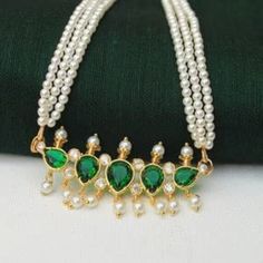 This traditional puneri pearl green stone studded tanmani can be beautifully worn with traditional outfits, festive wear, party wear, or even casual wear. The right gift for the lady love Surprise the love of your life on a very special day be it an anniversary, birthday, party, Valentine, or any other festival.Specially maharashtrian wedding ceremony. This peshwai green stone tanmani denhance your beauty. So buy now! So Hurry Up and Order Now! Traditional Green Jewelry With Stone Setting, Traditional Green Necklaces With Stone Setting, Traditional Green Necklace With Stone Setting, Festive Tilla Pearl Necklace, Green Bollywood Style Temple Necklace For Puja, Green Bollywood Temple Necklace For Puja, Bollywood Style Green Temple Necklace For Puja, Festive Green Pearl Drop Necklace, Green Temple Necklace For Diwali Puja