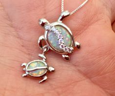 "Solid .925 Sterling Silver Hawaiian Lab Opal Mom and Baby Honu Turtle Necklace. The size is 25MMx17MM, about quarter size long. The hidden bail in Mom's flipper is 5MM. Momma Turtle has tiny Cubic Zirconias across her shell for a touch of bling. FREE Sterling Silver Italian Bead Chain included in your choice of length. --The Opals shift from Whites to Reds to Greens with hints of other colors in seemingly instantaneous iridescent flashes. Depending on your lighting these will be subtle to brigh Adjustable Stamped 925 Jewelry For Birthday, Adjustable Hallmarked Jewelry For Mother's Day, Hawaiian Necklace, Baby Sea Turtle, Hawaii Jewelry, Hawaiian Jewelry, Zirconia Necklace, Turtle Necklace, Cubic Zirconia Necklace