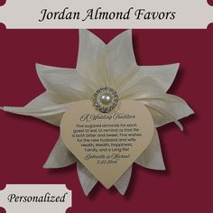 a white flower with a heart shaped tag attached to it's center and the words, jordan almondd favors