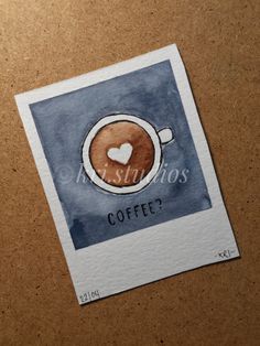 a coffee cup with a heart on it is sitting on top of a piece of paper