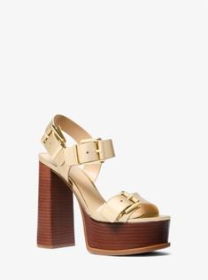 Made from supple metallic leather, the Colby platform sandals are defined by utilitarian buckles that create an element of ‘70s-inspired tough-luxe appeal. Thick straps and a sturdy block heel make them comfortable enough to wear all night. Leather Heels With Gold-tone Hardware For Spring, Gold Sandals With Chunky Platform And Block Heel, Spring Leather Heels With Gold-tone Hardware, Gold Elegant Platform Sandals, Luxury Gold Platform Wedge Sandals, Spring High Heel Sandals With Gold-tone Hardware, Gold High Heel Platform Sandals, Gold Leather Wedge Sandals With 4-inch Heel, Leather Platform Sandals