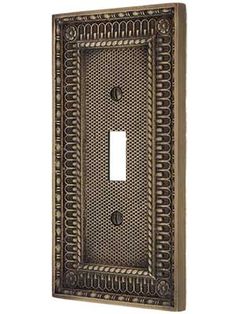 a decorative light switch plate cover with intricate designs on the front and back sides,