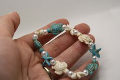 Blue and white bracelet with Turtle bead and Starfish charms made of synthetic turquoise beads and faux pearls on a strong and stretchy elastic string. Bracket Ideas, Blue And White Bracelet, Pulseras Ideas, Floss Bracelets, Kandi Inspo, Cherry Necklace, Trendy Bracelet, Starfish Bracelet, Multi Coloured Necklaces