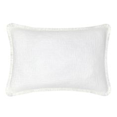 a white pillow with fringe trim on the front and back of it, against a white background