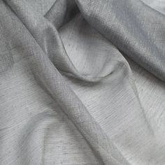 a close up shot of the grey fabric on a bed sheet that has been made from linen