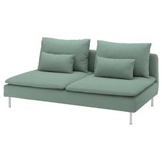 a green couch with two pillows on it and one arm folded back to the side