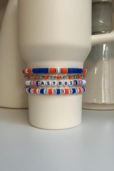 Cheer on the Houston Astros or your favorite Blue and Orange Team with this personalized collection of beaded bracelets hand crafted to add personal style to your Stanley cup.  🌟 Great for gift giving, holidays, sports, parties, and everyday charm. 🌟 Set includes 4 bracelets designed to fit the 40oz Stanley Quencher with a silicone boot in place.  🌟 Personalization will include "ASTROS" on the middle band as the standard. If you would like something different, please enter it in the personali Personalized Adjustable Beaded Bracelets As Souvenir, Casual Customized Blue Beaded Bracelets, Adjustable Beaded Bracelets With Letter Beads As Souvenir, Trendy Customized Blue Beaded Bracelets, Blue Round Bead Stretch Bracelet For Birthday, Casual Multicolor Jewelry For Personalized Gift, Blue Round Beads Stretch Bracelet For Birthday, Blue Round Beaded Stretch Bracelet For Birthday, Casual Blue Customizable Beaded Bracelets