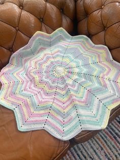 a crocheted doily sits on a leather chair