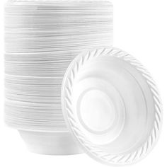 large stack of white plates stacked on top of each other in front of a white background