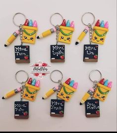 six different key chains with pencils and erasers on them