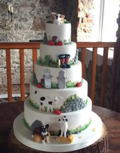 a three tiered cake with farm animals on it