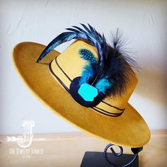 If you’re looking for the perfect accessory to complement your favorite boho style, look no further. This Boho-Style Western Felt Hat w/ Natural Feather & Turquoise Hat Accent by The Jewelry Junkie is absolutely everything that you need. Not only is it easy to incorporate into any and all outfits, but the genuine leather and natural feathers of the band immediately elevate whatever it is you’re wearing. One Size Hat with adjustable inner hat liner (see last photos) The same primary feathers will Bohemian Summer Felt Hat With Flat Brim, Bohemian Flat Brim Felt Hat For Summer, Bohemian Adjustable Hat Band With Feathers, Bohemian Fedora With Short Brim For Western-themed Events, Adjustable Blue Hat Bands For Fall, Bohemian Hats For Fall, Bohemian Mini Hat With Feathers, Bohemian Fall Hats One Size, Blue Brimmed Felt Hat For Festival