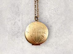 This world map globe locket necklace is the perfect gift for the traveler, romantic gift, a going away gift, graduation gift or a bon voyage gift! The map features both the Eastern and Western hemispheres on both sides of the locket- so you have the whole world.  This design is raw brass (gold color) and lead and nickel free. The locket opens up and down, pocket watch style. Hangs on a beautiful 22k matte gold plated chain or you may choose a keychain.  PERSONALIZE You can personalize your locke Compass Design Locket Necklace As A Gift, Compass Design Round Pendant Locket Necklace As Gift, Compass Design Medallion Locket Necklace As Gift, Medallion Locket Necklace With Compass Design For Gift, Vintage Compass Design Necklace As A Gift, Bon Voyage Gift, Wanderlust Necklace, Globe Necklace, Necklace Photo