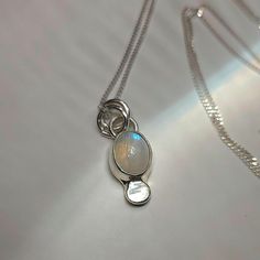 ✺ This sweet and celestial moonstone has been set in silver. Hanging from a sparkly 20-inch sterling silver curb chain necklace. ✺ M A T E R I A L S : * 20-inch sterling silver chain + clasp * sterling silver * moonstone A B O U T * T H I S * N E C K L A C E : This .925 sterling silver, copper + brass necklace was carefully designed with intention and creative motive. It should last you years to come with occasional polishing and delicate care. It is suggested to remove sterling silver jewelry b Ethereal Oval Moonstone Jewelry, Moon-shaped Moonstone Jewelry In White Gold, White Gold Moon-shaped Moonstone Jewelry, White Delicate Jewelry Gift, White Ethereal Jewelry For Gifts, Celestial Silver Oval Pendant Jewelry, White Moonstone Clavicle Chain Necklace, Ethereal Oval Jewelry For Gifts, Mystical White Moon Phase Jewelry