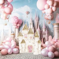 there is a castle with balloons in the air and some pink stuff on the ground