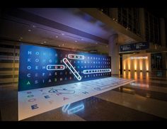 an airport lobby with illuminated letters and numbers on the floor