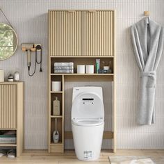 a white toilet sitting in a bathroom next to a wooden shelf filled with towels and other items