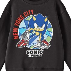 Celebrate your favorite animated series in comfort with this Sonic Prime sweatshirt. The shirt features an image of Sonic crouching in a font of a circle filled with geometric shapes while red letters read, "New Yoke City." Black letters below the image spell out the series logo. Fans of the Sonic Prime animated series will love this comfy and cozy sweatshirt. Casual Sweatshirt With Character Print, Crew Neck, Casual Crew Neck Sweatshirt With Character Print, Pop Culture Graphic Long Sleeve Tops, Black Crew Neck Sweatshirt With Character Print, Cotton Fandom Sweatshirt With Graphic Print, Cotton Fandom Graphic Sweatshirt, Pop Culture Cartoon Print Sweatshirt For Streetwear, Cotton Graphic Print Fandom Sweatshirt, Cotton Sweatshirt With Graphic Print For Fandom