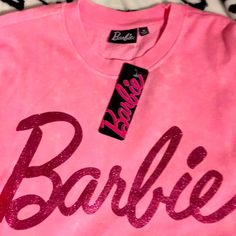 Brought 2 Pink With Glitter On Barbie Logo It’s A Long Version Length Not Crop. Thank You For Visiting My Closet! Pink Glitter Print Crew Neck Top, Pink Casual Top With Glitter Print, Casual Pink Tops With Glitter Print, Casual Pink T-shirt With Glitter Print, Barbie Top, Barbie Logo, Pink Sweatshirt, My Closet, Womens Tops