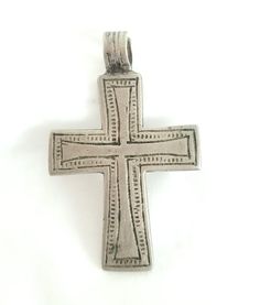 beautiful old handmade Ethiopian cross pendant made of  silver . In Ethiopia particularly among Orthodox Church followers, to wear a cross implied to be protected by the lord himself as well as to show that they are a devoted Christian. Neck or pictorial crosses are tied round their owner's neck with a piece of blue thread or cord, which was sometimes given to the wearer at baptism. This particular cross pendant is old and has been used. Measures approximatelty  1".5 x 2''.5  long Age: over 100 Bohemian Handmade Cross Necklace As Gift, Bohemian Handmade Cross Necklace For Gift, Handmade Bohemian Cross Necklace For Gift, Traditional Silver Cross Necklace, Handmade Antique Silver Cross Necklace, Bohemian Jewelry With Large Cross Pendant, Handmade Spiritual Cross Pendant Necklace, Vintage Handmade Cross Pendant Necklace, Nickel Free Spiritual Pendant Cross Necklace