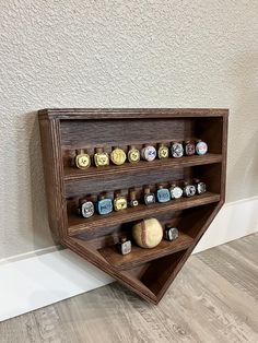 a wooden shelf with several different items on it and a baseball in the corner next to it