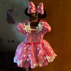 a minnie mouse dress hanging on a wall