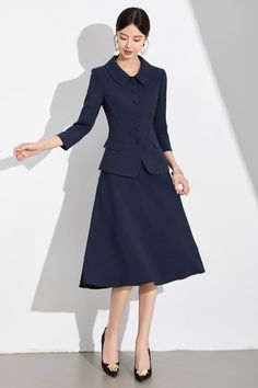 Navy Blue A-Line Skirt Suit with Peter Pan Collar for Classic Elegance Exude Classic Elegance with the Navy Blue A-Line Skirt Suit Discover timeless sophistication with our Navy Blue A-Line Skirt Suit, a wardrobe essential for the modern woman who values both style and grace. This two-piece ensemble features a beautifully tailored jacket with a chic Peter Pan collar and matching A-line skirt that gently flares to create a flattering silhouette. The jacket's structured design, complete with fabric-covered buttons and a cinched waist, adds a refined touch to your look, making it perfect for professional settings, formal events, or any occasion where you want to leave a lasting impression. Crafted from high-quality fabric, this skirt suit ensures comfort and durability, providing a polished l Coat And Skirt Formal, Coat And Skirt, Structured Jacket, Structured Design, Navy Skirt, Tailored Jacket, Fabric Covered Button, The Navy, Style And Grace